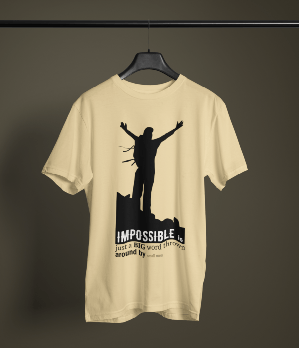 beige color impossible is just a big word thrown by small men graphic printed t-shirt on a hanger