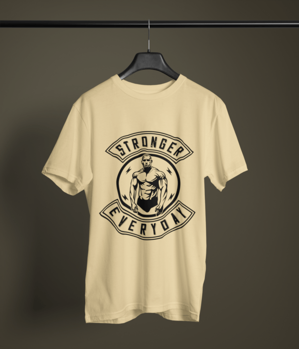 beige color stronger everyday graphic tee on a hanger