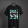 black color heavy weights and protein shakes graphic tee on a hanger