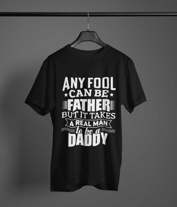 black-it-takes-real-man-to-be-a-daddy printed t-shirt on-a-hanger