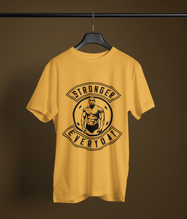 golden yellow color stronger everyday graphic tee on a hanger