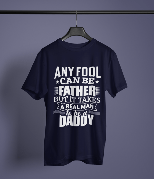 navy-blue-it-takes-real-man-to-be-a-daddy printed t-shirt on-a-hanger