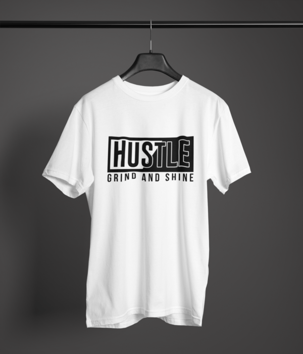 white color hustle grind and shine graphic printed t-shirt on a hanger